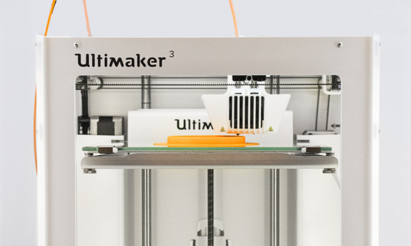 Ultimaker 3D printer printing an object with yellow filament