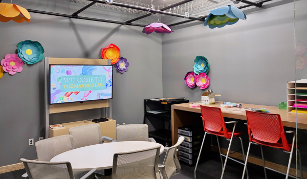 Maker's Lab at Varina Area Library with large TV screen, seating areas, and crafting supplies.